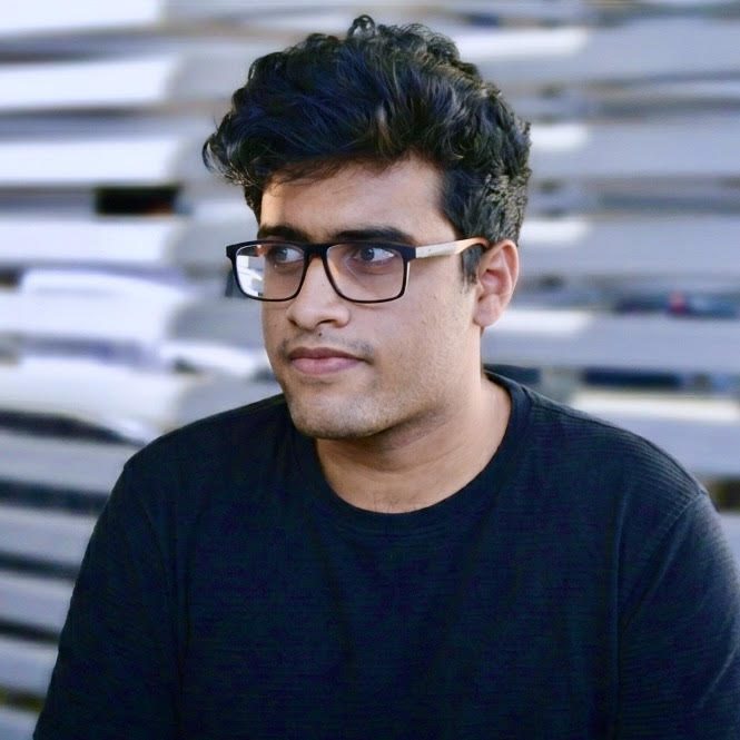 Sam wearing glasses, looking to the side